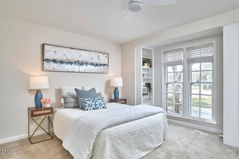 a bedroom with a bed and a large window