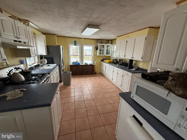 a kitchen with a sink appliances and cabinets