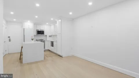 a view of kitchen with stainless steel appliances cabinets