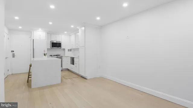 a view of kitchen with stainless steel appliances cabinets
