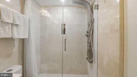 a bathroom with a glass shower door