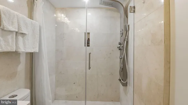 a bathroom with a glass shower door
