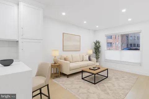 a living room with furniture and a painting on the wall