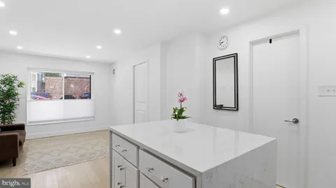 a view of hallway with sink and wooden floor