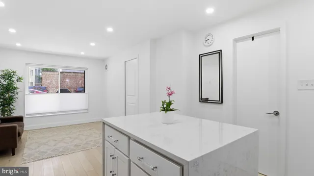 a view of hallway with sink and wooden floor