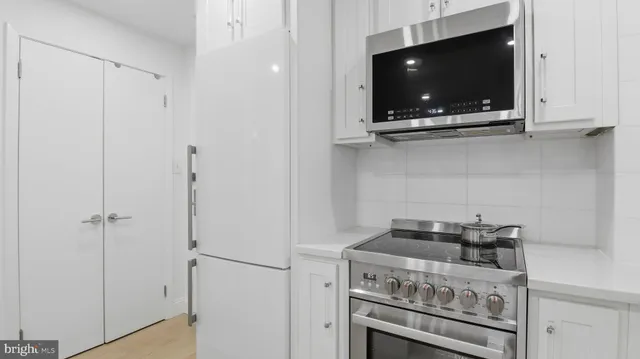 a kitchen with a stove and a microwave