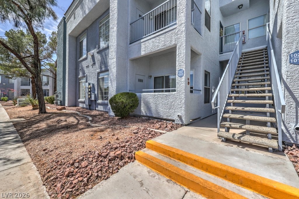 2201 Ramsgate Drive, Unit 1017 Henderson, NV 89074 - Photo 3 of 30 This multi-level residence features outdoor staircases and private balconies, offering a harmonious blend of indoor and outdoor living.