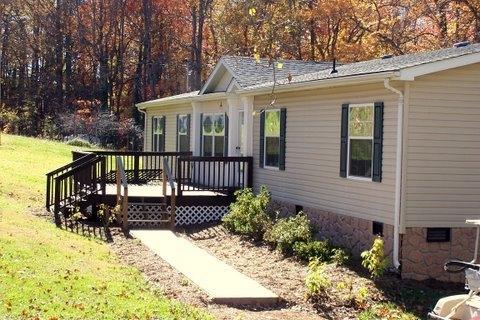 261 Munsons Road Penhook, VA 24137 - Photo 2 of 29 a view of a house with a yard and wooden deck