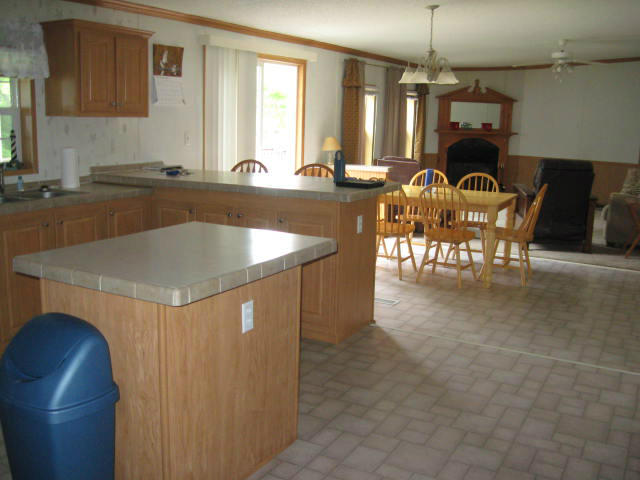 261 Munsons Road Penhook, VA 24137 - Photo 15 of 29 a kitchen with a table chairs sink and cabinets