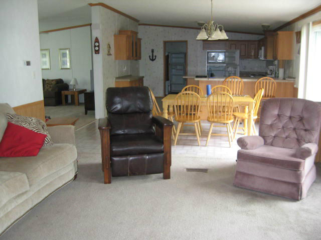 261 Munsons Road Penhook, VA 24137 - Photo 16 of 29 a living room with furniture a dining table and a chandelier
