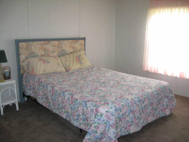 261 Munsons Road Penhook, VA 24137 - Photo 19 of 29 a bed sitting in a bedroom next to a window