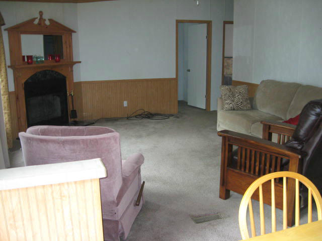 261 Munsons Road Penhook, VA 24137 - Photo 3 of 29 a living room with furniture and a fireplace