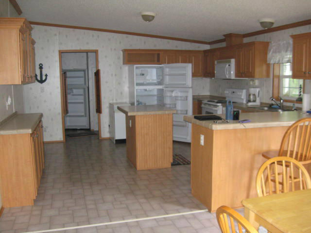 261 Munsons Road Penhook, VA 24137 - Photo 5 of 29 a kitchen with a refrigerator and a stove