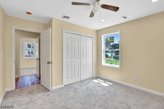 an empty room with windows and closet