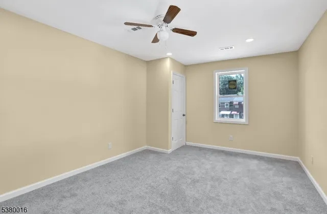 a view of room with a ceiling fan