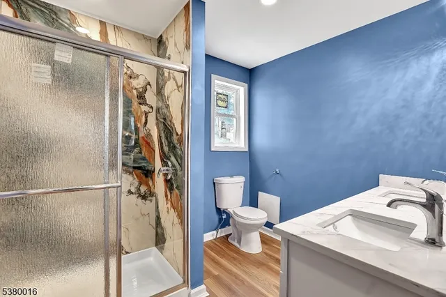 a bathroom with a sink toilet and shower