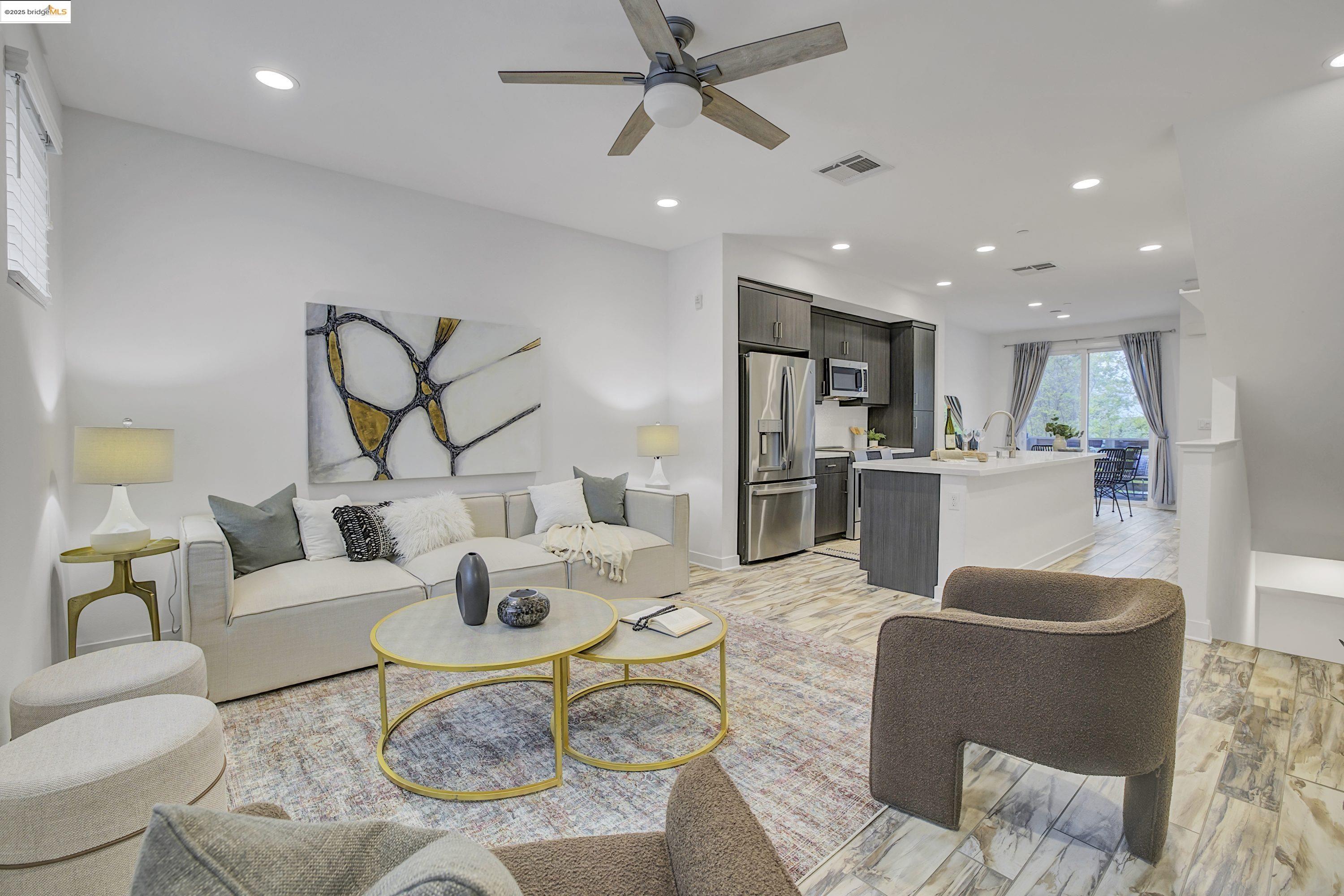 a living room with furniture and kitchen view