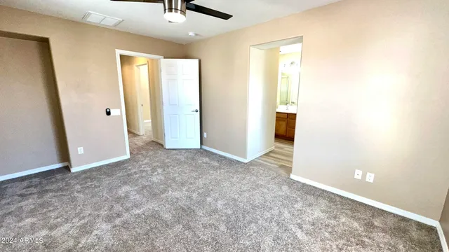 an empty room with windows and closet