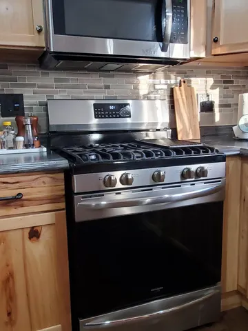 a stove top oven sitting inside of a kitchen
