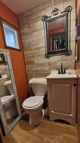 a bathroom with a toilet sink and mirror