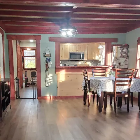 a view of a dining room with furniture and wooden floor