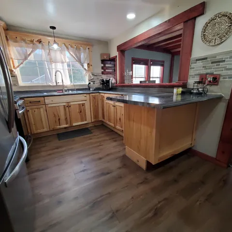 a kitchen with wooden floors and a sink