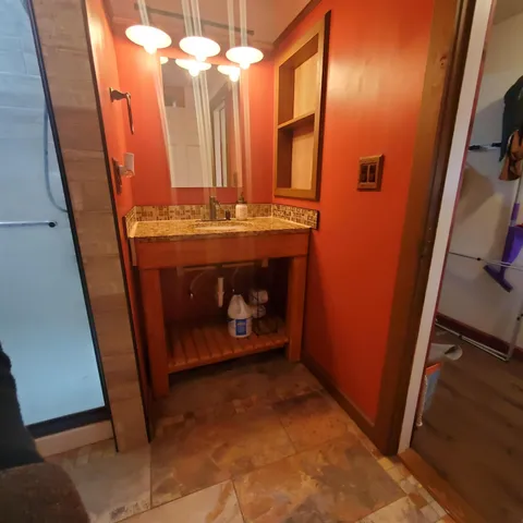 a bathroom with a sink and a mirror