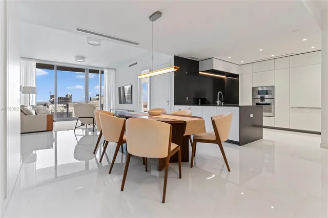 a living room with furniture a dining table and kitchen view