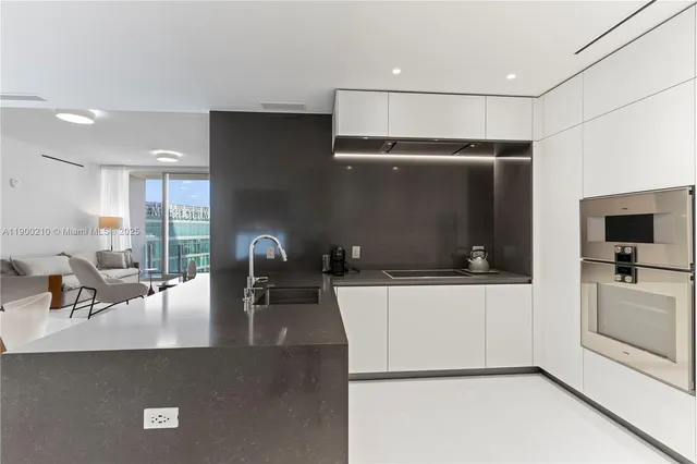 a kitchen with a sink stainless steel appliances and cabinets
