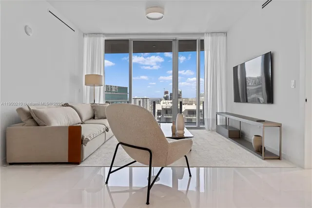 a living room with furniture and a large window