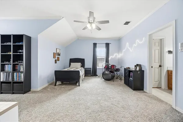 a bedroom with a bed and a television
