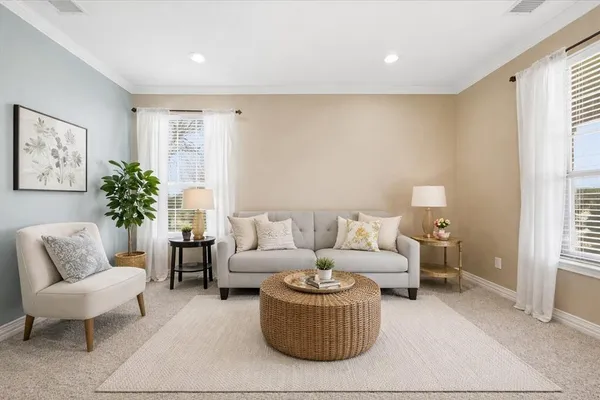 a living room with furniture and a chandelier
