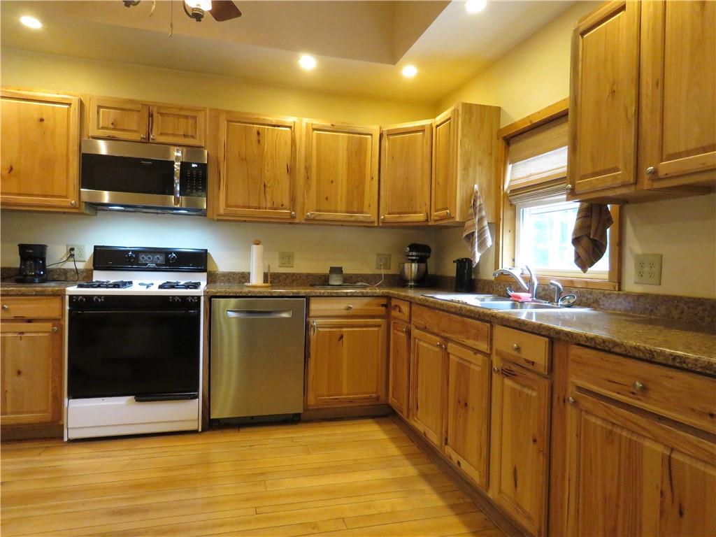 1225 Kentuck Road Ohiopyle, PA 15470 - Photo 4 of 24 a kitchen with stainless steel appliances granite countertop a stove a sink and a microwave