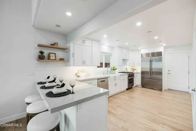 a view of white cabinets and rack on the wall