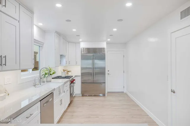 a kitchen with a white stove top oven and cabinets
