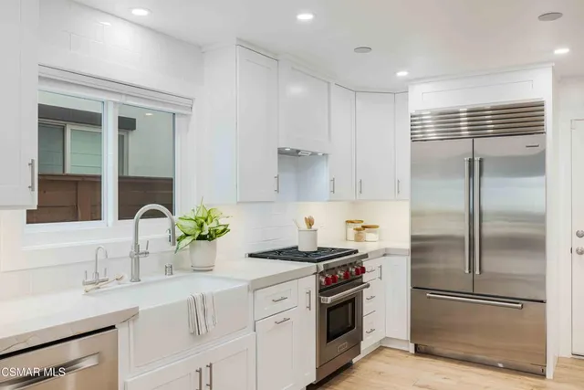 a bathroom with a sink and mirror with toilet