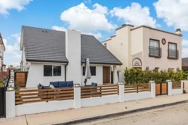 a view of a patio with couches and a potted plant on a table