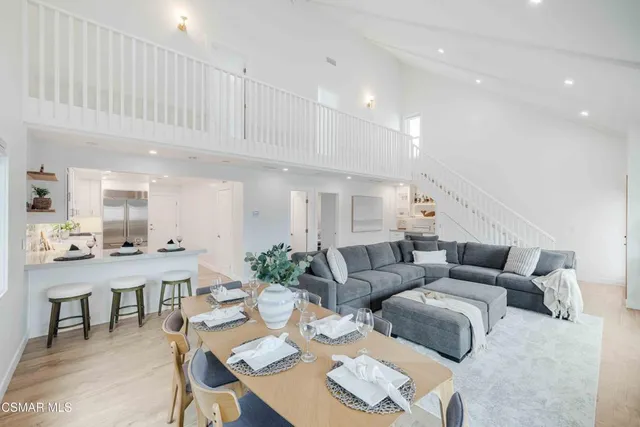 a kitchen with stainless steel appliances white cabinets and wooden floors