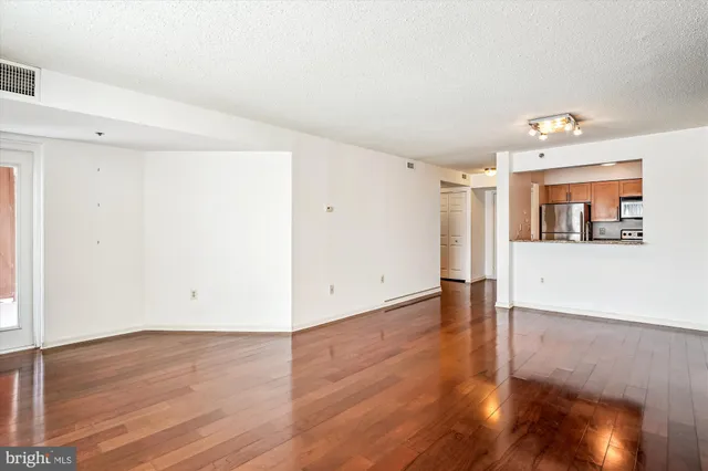 a view of a living room with wooden floor