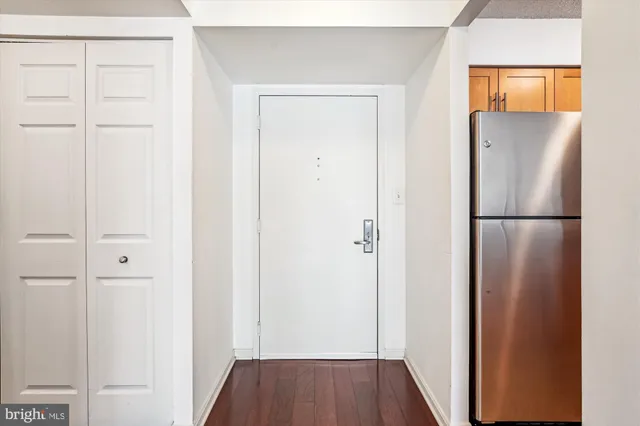 a view of a hallway with wooden floor and entryway