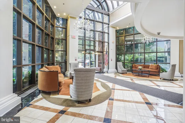 a living room with furniture and a floor to ceiling window