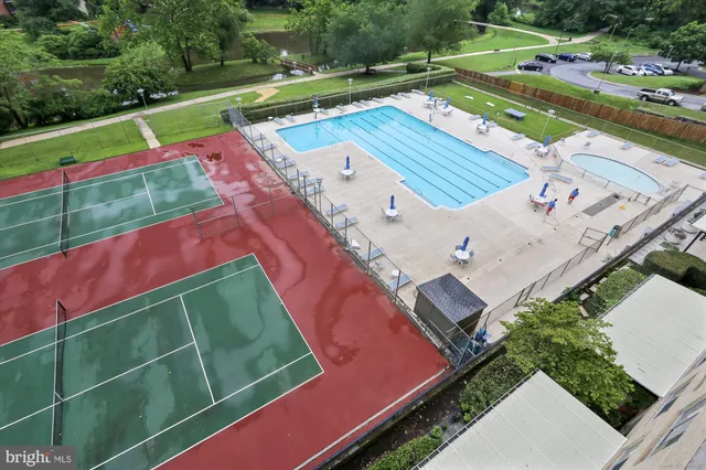 a view of a multi story building with a yard and swimming pool