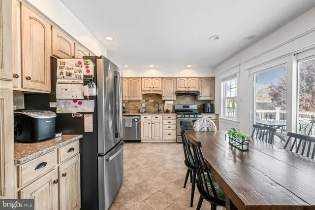 a kitchen with a white cabinets and chandelier