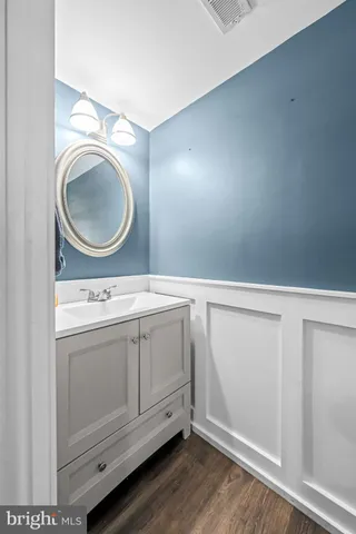 a bedroom with furniture and a wooden floor