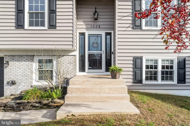 a front view of a house with potted plants