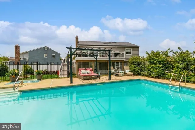 a view of yard with swimming pool and trees