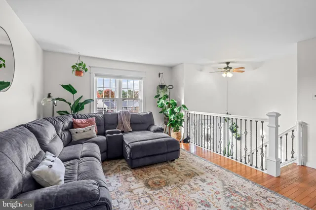 a bedroom with furniture and a wooden floor