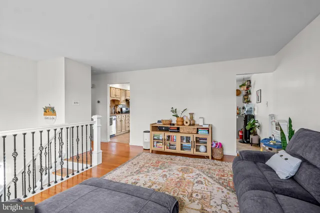 a kitchen with granite countertop a table chairs sink and cabinets