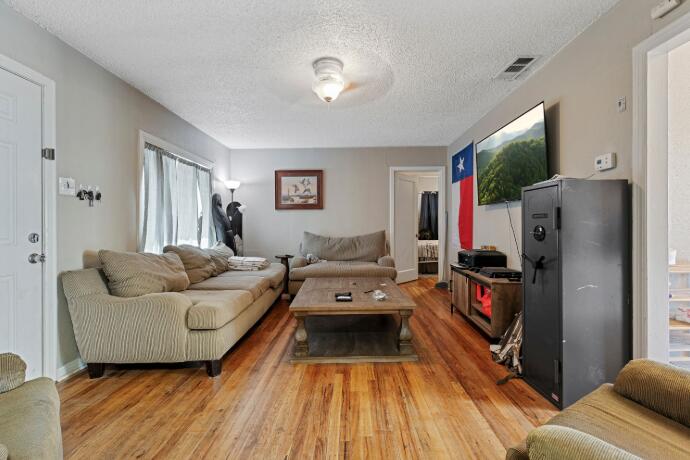 3004 33rd Street Lubbock, TX 79410 - Photo 2 of 10 a living room with furniture and a flat screen tv