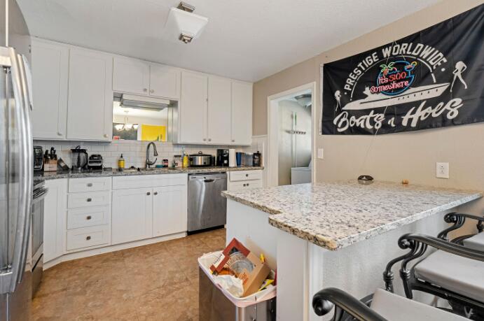 3004 33rd Street Lubbock, TX 79410 - Photo 4 of 10 a kitchen with a sink a stove and cabinets